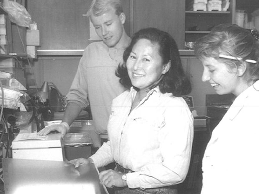 Archival black and white photo of researchers in a lab